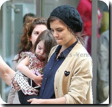 Tom Cruise, Katie Holmes
with their daughter Suri leaving the Nike store.