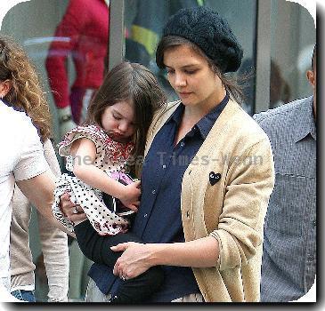 Tom Cruise, Katie Holmes
with their daughter Suri leaving the Nike store.