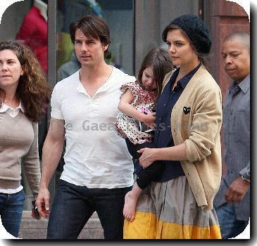 Tom Cruise, Katie Holmes
with their daughter Suri leaving the Nike store.