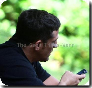 ***Exclusive***
Alex Reid
talks on the phone while sitting on some steps near his home..