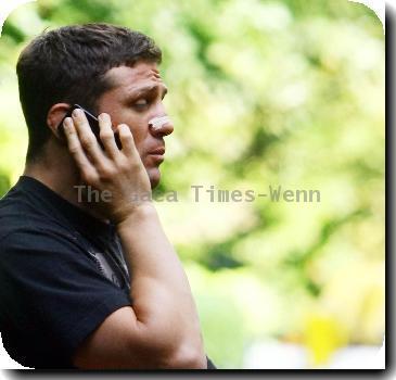 ***Exclusive***
Alex Reid
talks on the phone while sitting on some steps near his home..