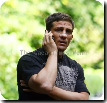 ***Exclusive***
Alex Reid
talks on the phone while sitting on some steps near his home..