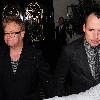 Elton John and David Furnish holding hands as they leave Scotts restaurant.