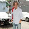 Eric Clapton has lunch at Orso restaurant, then walks back to his car with his guitar in West Hollywood..