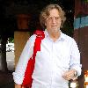 Eric Clapton has lunch at Orso restaurant, then walks back to his car with his guitar in West Hollywood..