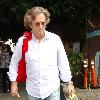 Eric Clapton has lunch at Orso restaurant, then walks back to his car with his guitar in West Hollywood..