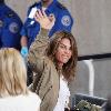 Fitness guru Jillian Michaels passes through airport security checkpoint to catch a flight.