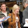 Olivia Newton-John 
signs autographs outside the BBC Radio 2 studios with her husband.