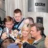 Olivia Newton-John 
signs autographs outside the BBC Radio 2 studios with her husband.