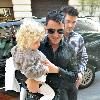 Peter Andre carries his daughter Princess Tiaamii
outside their hotel in central London.