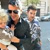 Peter Andre carries his daughter Princess Tiaamii
outside their hotel in central London.