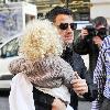 Peter Andre carries his daughter Princess Tiaamii
outside their hotel in central London.