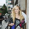 Fearne Cotton signs autographs as she leaves BBC Radio studios carrying a pair of blue headphones and wearing feathers in her hair.