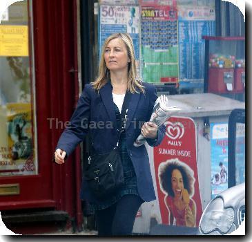 Fiona Phillips chats on her mobile phoneas she takes a stroll near her homeLondon.