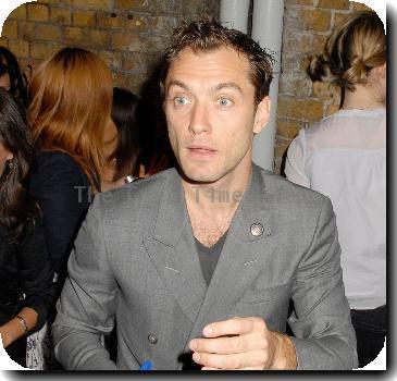 Jude Law signs autographs for waiting fans as he leaves the Wyndham's TheatreLondon.