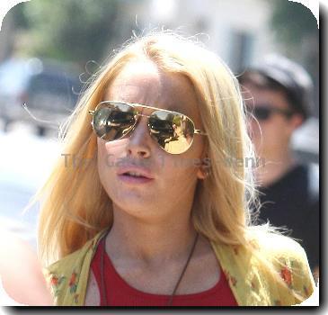 Lindsay Lohan leaving her Hollywood residence wearing short shorts and reflective Ray-Ban Aviator.