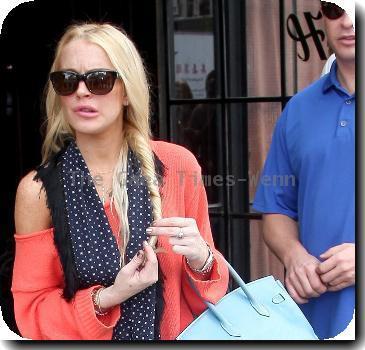 Lindsay Lohan leaving her Manhattan hotel while wearing skinny jeans and untied black boots New York City.