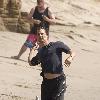 Matthew McConaughey soaks up the Southern California sun playing with his dogs and exercising along Malibu beach.