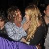 Mickey Rourke leaving Mahiki nightclub with a mystery blonde.