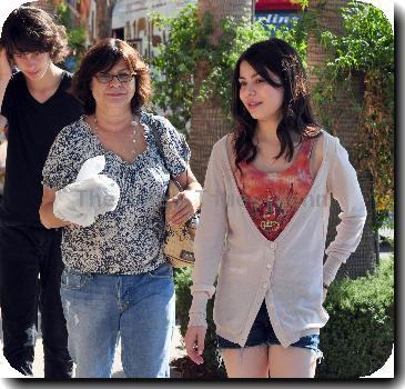 Miranda Cosgrove shopping in Hollywood with her friends and familyCalifornia.