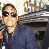 Robbie Williams signing autographs for fans as he arrives at Radio one studios.