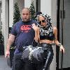 Lady GaGa makes a dramatic exit from the May Fair hotel, wearing a pvc outfit and a headscarf..