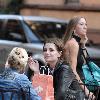 Mischa Barton enjoys a snack and a smoke with friends in the West Village New York City.