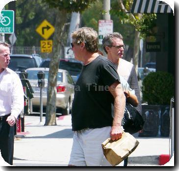 Ryan O'Neal takes food to go after having lunch with a friend.