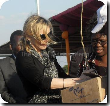 * MADONNA PLANTS TREE TO LAUNCH MALAWI SCHOOL PROJECT MADONNA marked the launch of her girls' school in Malawi by planting a sapling and vowing to provide impoverished locals with the same education opportunities she had growing up. The Material Girl jetted into Malawi - the homeland of her two adopted children David Banda and Mercy James - at the weekend (24-25Oct) to oversee the launch of the school, which is being funded through her Raising Malawi charity. The facility will provide education for 200 local girls who are too poor to afford schooling, and will cost $13.5 million (£9 million) to build. The superstar greeted local officials and construction workers as she laid the first brick. And after planting a young tree to represent the school's beginning, the singer explained her reasons for wanting to finance the project. She said,