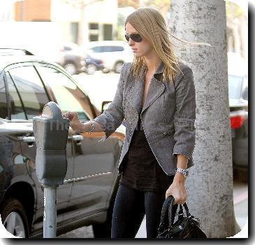 Nicky Hilton putting money in a parking meter while out and about in Beverly Hills Los Angeles.