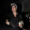 Singer Amy Winehouse smokes a cigarette after leaving the Fish Works Restaurant in Marylebone. London.