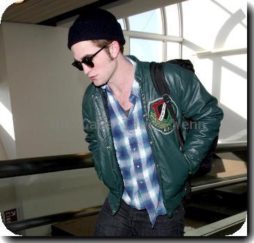 Robert Pattinson arriving at LAX airport while wearing a black winter hat Los Angeles.