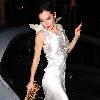 Anna Friel wearing a long white dress, angel wings and a feather mask, leaves the Theatre Royal after her latest stage performance in 'Breakfast At Tiffany's'London.