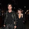 Kelly Brook and her boyfriend Danny Cipriani look surprised to be photographed as they leave J Sheekey restaurant hand in hand. Kelly was wearing a low cut dress, and appeared to realise this as she was being photographed, because she readjusted her dress to try and cover up a bit!.