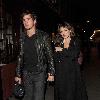 Kelly Brook and her boyfriend Danny Cipriani look surprised to be photographed as they leave J Sheekey restaurant hand in hand. Kelly was wearing a low cut dress, and appeared to realise this as she was being photographed, because she readjusted her dress to try and cover up a bit!.