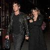 Kelly Brook and her boyfriend Danny Cipriani look surprised to be photographed as they leave J Sheekey restaurant hand in hand. Kelly was wearing a low cut dress, and appeared to realise this as she was being photographed, because she readjusted her dress to try and cover up a bit!.