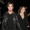 Kelly Brook and her boyfriend Danny Cipriani look surprised to be photographed as they leave J Sheekey restaurant hand in hand. Kelly was wearing a low cut dress, and appeared to realise this as she was being photographed, because she readjusted her dress to try and cover up a bit!.