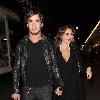 Kelly Brook and her boyfriend Danny Cipriani look surprised to be photographed as they leave J Sheekey restaurant hand in hand. Kelly was wearing a low cut dress, and appeared to realise this as she was being photographed, because she readjusted her dress to try and cover up a bit!.