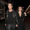 Kelly Brook and her boyfriend Danny Cipriani look surprised to be photographed as they leave J Sheekey restaurant hand in hand. Kelly was wearing a low cut dress, and appeared to realise this as she was being photographed, because she readjusted her dress to try and cover up a bit!.