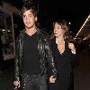 Kelly Brook and her boyfriend Danny Cipriani look surprised to be photographed as they leave J Sheekey restaurant hand in hand. Kelly was wearing a low cut dress, and appeared to realise this as she was being photographed, because she readjusted her dress to try and cover up a bit!.