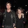 Kelly Brook and her boyfriend Danny Cipriani look surprised to be photographed as they leave J Sheekey restaurant hand in hand. Kelly was wearing a low cut dress, and appeared to realise this as she was being photographed, because she readjusted her dress to try and cover up a bit!.