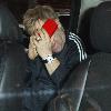 Sir Elton John hides his face while leaving his hotel in Manhattan with his partner.