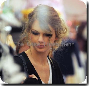 American singing sensation Taylor Swift leaves her hotel to go shopping for the day with friends in Notting Hill and Portobello Road Market. Taylor spent over 3 hours in the market, visiting various clothes shops, antique shops and furniture shops, before stopping off at a restaurant to finish her day. Along the way she posed for pictures with delighted fans, and more or less brought the market to a standstill, with around 100 people following her every move. London.