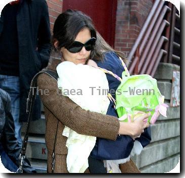 Katie Holmes and Suri Cruise Katie Holmes carrying her daughter Suri as they leave a theatre after attending Complexions Contemporary Ballet New York City.