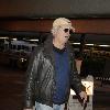 Chevy Chase arrives at LAX airport on an American Airlines flight from New York City.Los Angeles, California.