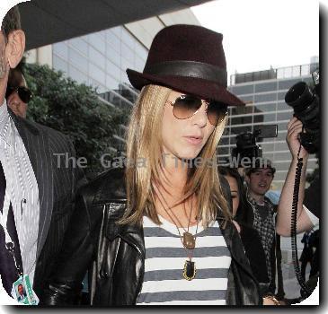 Jennifer Aniston arriving at LAX airport sporting ripped jeans, striped tops, and leather jacketLos Angeles.