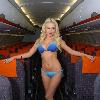 Glamour model Laura Lacole
previews the new easyJet Airbus A319 at Belfast?s International Airport.  Laura was specially invited by easyJet marketing manager Trevor Spinks and the captain into the cockpit of the plane to get an insight into flying the new planes.  The new easyJet Airbus A319 gives customers and staff much more room when travelling as glamorous Laura shows as she poses as a member of the cabin crew on the aircraft.  Laura said: \