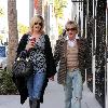 Penny Lancaster and Rod Stewart 
holding hands while out and about in Beverly Hills.