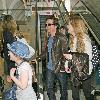 Michael J Fox arrives at LAX airport with his family and get in their waiting van.