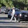 Bradley Cooper arrives back home in his Toyota Prius car, wearing a military cap and sleeper type shoes and blue tint sunglassesLos Angeles.